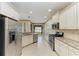 Spacious kitchen featuring granite counters, stainless steel appliances, and white cabinetry at 6516 Palm Leaf Ct, Sarasota, FL 34243