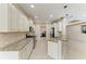 Open kitchen layout with granite counters, stainless steel appliances, and island seating at 6516 Palm Leaf Ct, Sarasota, FL 34243