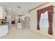 Open kitchen layout with granite counters, stainless steel appliances, and view of the dining area at 6516 Palm Leaf Ct, Sarasota, FL 34243