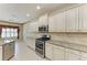 Well-lit kitchen with granite counters, stainless steel appliances, and white cabinets at 6516 Palm Leaf Ct, Sarasota, FL 34243