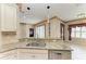 Granite-topped kitchen island with a stainless steel dishwasher and views of the dining area at 6516 Palm Leaf Ct, Sarasota, FL 34243