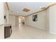 Open living area with neutral tile flooring, decorative trim, and a view of the foyer at 6516 Palm Leaf Ct, Sarasota, FL 34243