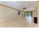 Spacious living room with tile flooring and access to the outdoor screened-in patio at 6516 Palm Leaf Ct, Sarasota, FL 34243