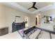 Spacious main bedroom featuring a tray ceiling, ceiling fan, and an ensuite bathroom at 6516 Palm Leaf Ct, Sarasota, FL 34243
