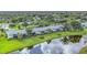 Aerial view of the complex showcasing a scenic lake and well-maintained landscaping at 7110 Fairway Bend Ln # 181, Sarasota, FL 34243
