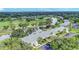 Scenic aerial view showcasing the condo's proximity to a golf course and lake at 7110 Fairway Bend Ln # 181, Sarasota, FL 34243