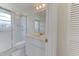 Compact bathroom featuring a white vanity, toilet, and shower with glass door at 7110 Fairway Bend Ln # 181, Sarasota, FL 34243