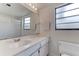 Bright bathroom featuring a large mirror, a white vanity, and a shower with glass doors at 7110 Fairway Bend Ln # 181, Sarasota, FL 34243