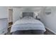 Comfortable bedroom with gray furnishings, a large bed, and view into en-suite bath at 7110 Fairway Bend Ln # 181, Sarasota, FL 34243