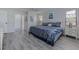 Comfortable bedroom with a patterned duvet, complemented by a dresser, side tables, and generous natural light at 7110 Fairway Bend Ln # 181, Sarasota, FL 34243