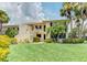 Inviting two-story condo with lush landscaping, mature palms, and manicured lawn at 7110 Fairway Bend Ln # 181, Sarasota, FL 34243