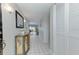 Bright hallway featuring tile flooring, closet and decorative cabinet with storage at 7110 Fairway Bend Ln # 181, Sarasota, FL 34243