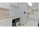 Bright kitchen features white cabinets, laminate countertops, and modern appliances for a clean aesthetic at 7110 Fairway Bend Ln # 181, Sarasota, FL 34243