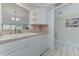 Efficient kitchen space featuring white cabinets and appliances with sink and dishwasher at 7110 Fairway Bend Ln # 181, Sarasota, FL 34243