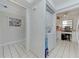 Bright laundry area features a stacked washer and dryer with tile flooring and natural light from the desk area at 7110 Fairway Bend Ln # 181, Sarasota, FL 34243