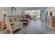 Relaxing living room with wood flooring, comfortable seating, and large windows with natural light at 7110 Fairway Bend Ln # 181, Sarasota, FL 34243