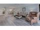 Spacious living room with wood flooring, comfortable seating, and an open layout for easy living at 7110 Fairway Bend Ln # 181, Sarasota, FL 34243