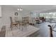 Open-concept living room with wood flooring, dining area, comfortable seating, and large windows with natural light at 7110 Fairway Bend Ln # 181, Sarasota, FL 34243