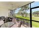 Screened in patio with outdoor seating and views of a beautiful lake and tropical landscaping at 7110 Fairway Bend Ln # 181, Sarasota, FL 34243