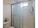 Tiled shower with a sliding glass door and decorative accents at 7137 Cedar Hollow Cir, Bradenton, FL 34203