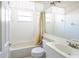 Bright bathroom featuring tile, a shower and tub combo, and a large mirror at 7137 Cedar Hollow Cir, Bradenton, FL 34203