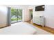 Bedroom with a glass sliding door to a screened lanai and a flat screen TV at 7137 Cedar Hollow Cir, Bradenton, FL 34203