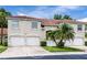 Charming townhome featuring a well-manicured lawn and a classic red tile roof at 7137 Cedar Hollow Cir, Bradenton, FL 34203