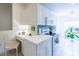 Bright kitchen features white cabinets, stainless steel appliances, blue backsplash, plus a convenient desk area at 7137 Cedar Hollow Cir, Bradenton, FL 34203