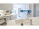 Bright kitchen featuring white cabinets and a blue backsplash, plus a large stainless sink at 7137 Cedar Hollow Cir, Bradenton, FL 34203