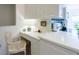 Kitchen area features white cabinets, a stainless steel cooktop, and a charming workstation at 7137 Cedar Hollow Cir, Bradenton, FL 34203