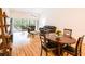 Spacious living room with wood flooring and open access to screened patio and dining area at 7137 Cedar Hollow Cir, Bradenton, FL 34203
