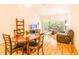 Open-concept living room featuring wood-look floors, a dining area, and access to a screened patio at 7137 Cedar Hollow Cir, Bradenton, FL 34203