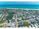 An aerial view showcases a neighborhood, highlighting the home's proximity to the river and the ocean at 733 Holly Rd, Anna Maria, FL 34216