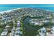 An aerial view showcases a neighborhood, highlighting the home's proximity to the river and the ocean at 733 Holly Rd, Anna Maria, FL 34216