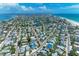 A wide aerial shot capturing a coastal community nestled between a bayou, the ocean, and beach at 733 Holly Rd, Anna Maria, FL 34216