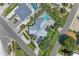 Aerial view of a home with a metal roof, surrounded by manicured landscaping and a private pool at 733 Holly Rd, Anna Maria, FL 34216
