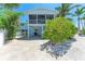 Home featuring a spacious screened patio with a fan, providing the perfect area to relax at 733 Holly Rd, Anna Maria, FL 34216