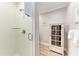 Bathroom featuring tiled walk-in shower and a vintage-style cabinet at 733 Holly Rd, Anna Maria, FL 34216