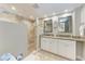 Modern bathroom featuring a glass-enclosed shower and double vanity with granite countertops at 733 Holly Rd, Anna Maria, FL 34216