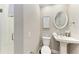 Cozy bathroom featuring a pedestal sink, toilet, and glass-enclosed shower with white subway tile at 733 Holly Rd, Anna Maria, FL 34216