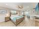 Spacious bedroom featuring a wooden bed frame and an attached sitting room at 733 Holly Rd, Anna Maria, FL 34216