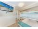 Bunkbed bedroom with TV and adjacent bathroom at 733 Holly Rd, Anna Maria, FL 34216