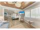 Comfortable bedroom featuring a ceiling fan, TV, wicker chair and a view of the Primary bedroom at 733 Holly Rd, Anna Maria, FL 34216