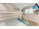 Beach themed bedroom features white bunk beds, wood look floors, and mounted TV at 733 Holly Rd, Anna Maria, FL 34216
