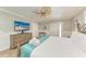Bedroom featuring a wooden bed frame, dresser with TV and access to a patio at 733 Holly Rd, Anna Maria, FL 34216