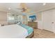 Bedroom with a ceiling fan, wood-look tile floors, and an attached sitting area at 733 Holly Rd, Anna Maria, FL 34216