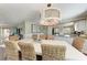 Charming dining room with wood floors, a chandelier, and open views of the kitchen at 733 Holly Rd, Anna Maria, FL 34216