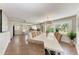 Inviting dining room featuring wood floors, a chandelier, and a full view of the kitchen at 733 Holly Rd, Anna Maria, FL 34216