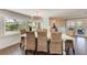 Bright dining room with wood floors, seating for eight, and large windows for natural light at 733 Holly Rd, Anna Maria, FL 34216