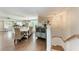 Elegant dining room with wood floors, seating for eight, and stairs leading up at 733 Holly Rd, Anna Maria, FL 34216